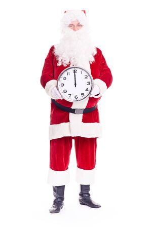Portrait of Santa Claus in traditional costume holding clocks showing midnightの写真素材