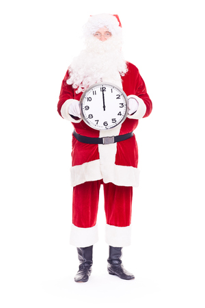 Portrait of Santa Claus in traditional costume holding clocks showing midnightの写真素材