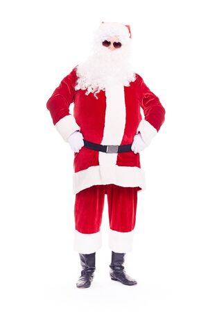 Portrait of cool Santa Claus in traditional costume wearing sunglasses on white backgroundの写真素材
