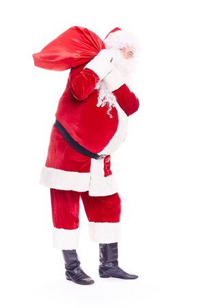 Portrait of Christmas character Santa Claus in traditional costume with red sack on white backgroundの写真素材