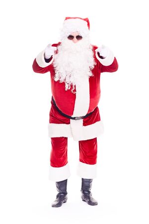 Portrait of cool Santa Claus in traditional costume wearing sunglasses on white backgroundの写真素材