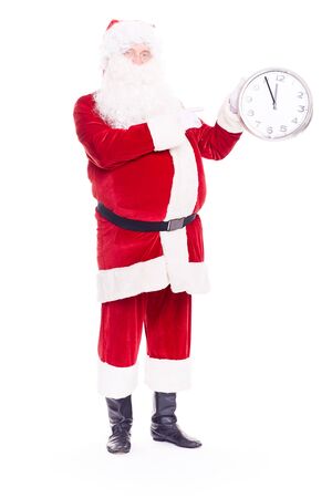 Portrait of Santa Claus in traditional costume holding clock showing five minutes to twelveの写真素材