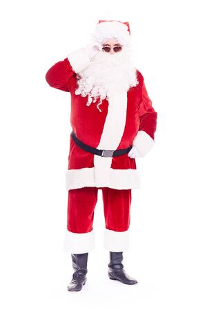 Portrait of cool Santa Claus in traditional costume wearing sunglasses on white backgroundの写真素材