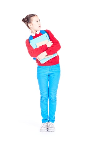 Portrait of female student holding notebooks and textbooks on white backgroundの写真素材