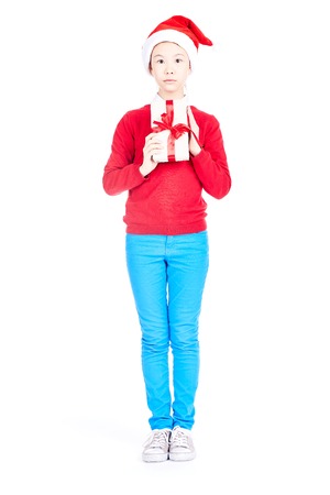 Asian girl in Santa hat holding Christmas gift isolated on whiteの写真素材