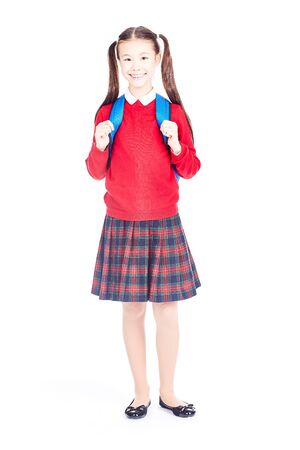 Asian female elementary student in school uniform posing on white backgroundの写真素材