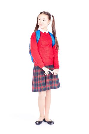 Asian female elementary student in school uniform posing on white backgroundの写真素材