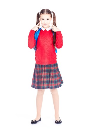 Asian female elementary student in school uniform posing on white backgroundの写真素材