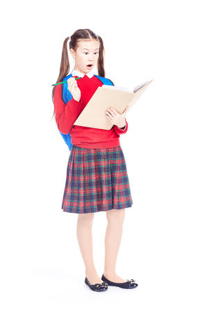Full length portrait of Korean schoolgirl holding open notebook and pencilの写真素材