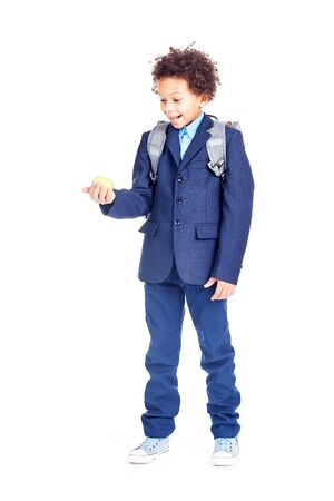 Portrait of cute mixed race boy with curly hair wearing school uniformの写真素材