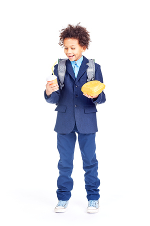 Portrait of cute mixed race boy with curly hair wearing school uniformの写真素材