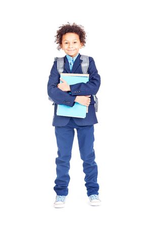 Portrait of cute mixed race boy with curly hair wearing school uniformの写真素材