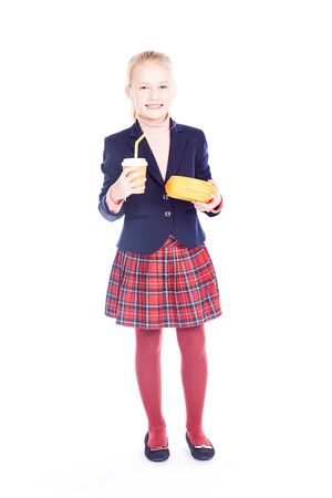 Studio portrait of beautiful blonde elementary student wearing school uniformの写真素材