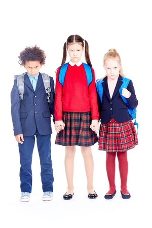 Studio portrait of multi-ethnic school friends wearing uniformの写真素材