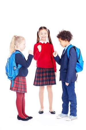 Studio portrait of multi-ethnic school friends wearing uniformの写真素材