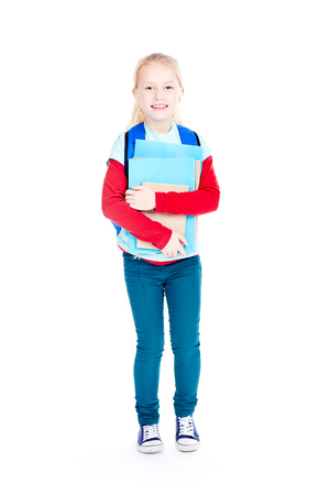 Portrait of cute schoolgirl in casual clothes smiling on white backgroundの写真素材