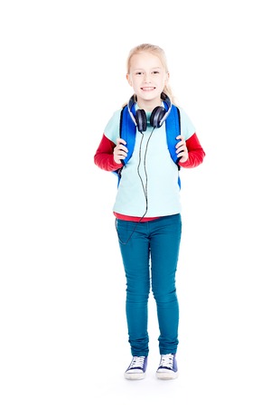 Portrait of little girl with earphones walking to schoolの写真素材