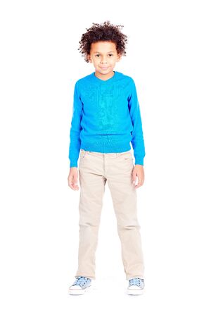 Portrait of cute curly-haired Latin American boy posing on white backgroundの写真素材