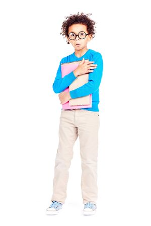 Portrait of cute curly-haired Latin American elementary student wearing eyeglassesの写真素材