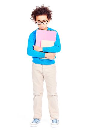 Portrait of cute curly-haired Latin American elementary student wearing eyeglassesの写真素材