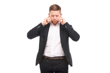Portrait of young Caucasian businessman in black suit and white shirt posing on white backgroundの写真素材