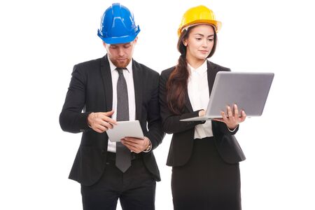 Portrait of male and female engineers wearing hardhatsの写真素材