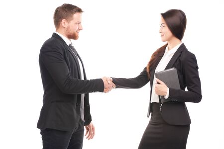 Portrait of Caucasian businessman and Asian businesswoman cooperatingの写真素材