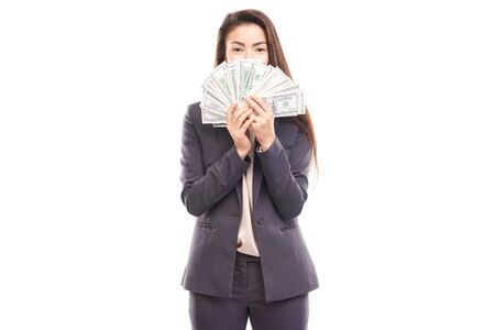 Portrait of young Asian businesswoman posing with paper currencyの写真素材