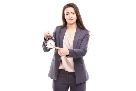 Young businesswoman holding alarm clock isolated on whiteの写真素材