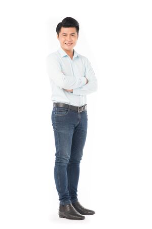 Portrait of confident Asian man wearing shirt and jeans posing on white backgroundの写真素材