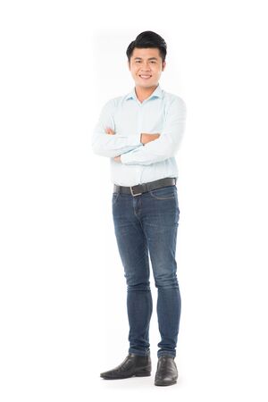 Portrait of confident Asian man wearing shirt and jeans posing on white backgroundの写真素材