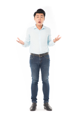 Studio portrait of young Asian man expressing emotions on white backgroundの写真素材