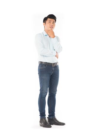 Studio portrait of young Asian man expressing emotions on white backgroundの写真素材