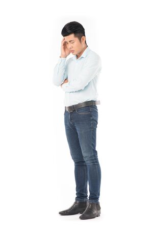 Studio portrait of young Asian man expressing emotions on white backgroundの写真素材