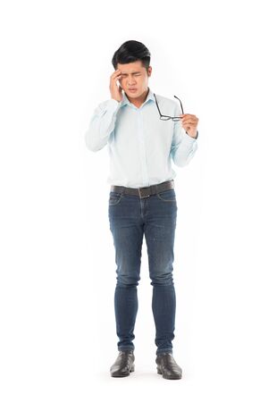 Full length portrait of young Asian man suffering from headache isolated on whiteの写真素材