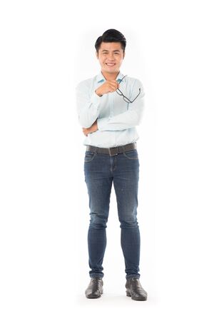 Portrait of young Asian man holding eyeglasses isolated on whiteの写真素材