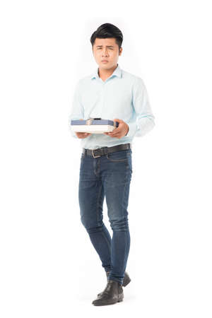 Studio portrait of young Asian man holding gift boxの写真素材