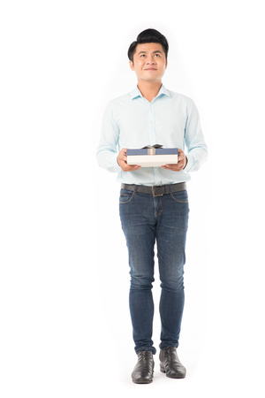 Studio portrait of young Asian man holding gift boxの写真素材