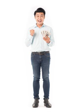 Portrait of young Asian man holding dollar billsの写真素材