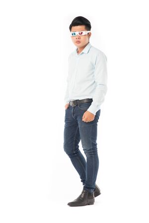 Portrait of young Asian man wearing 3d cinema glasses on white backgroundの写真素材