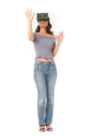 Studio portrait of Asian girl wearing VR headset and experiencing virtual reality