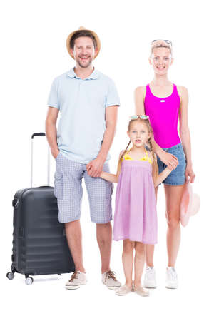 Vertical full length studio portrait of family with one child wearing summer outfits ready to travel on vacation, white backgroundの写真素材