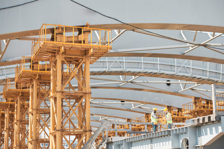 Low angle shot of residential building under construction with brick and concrete structure against blue sky, copy spaceの写真素材