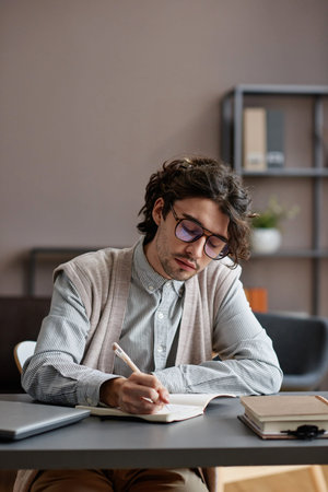 Vertical medium portrait of handsome young adult man wearing stylish casual outfit with eyeglasses...