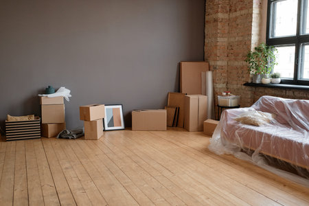 Horizontal no people shot of modern loft living room in spacious apartment with boxes, sofa and...