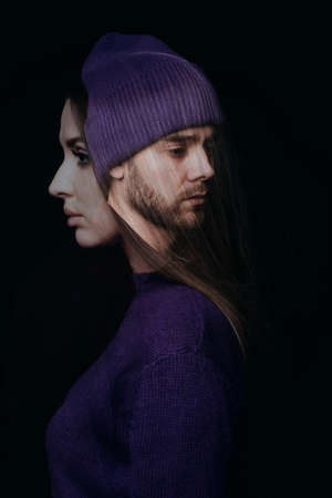 Double exposure photo of sad bearded man in violet hat and beautiful long-haired woman in violet sweater on dark backgroundの写真素材