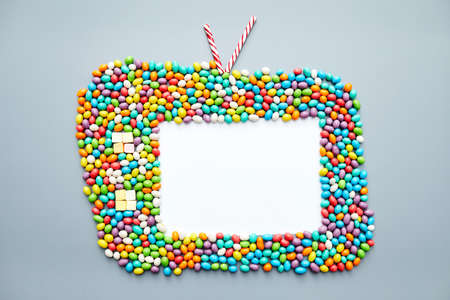 Old-fashioned television set made of candies such as jellybeans, candy canes, marshmallowsの写真素材