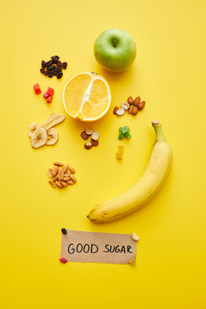 Examples of good sugar concept: directly above view of nuts, fresh and dried fruits on yellow...