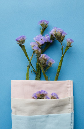 Close-up of cute blue flowers wrapped in napkin placed on served table, decoration conceptの写真素材