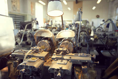 Close-up of modern lathe with metal shavings illuminated lamp, copy spaceの写真素材